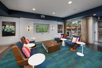 A resident clubhouse with a tv and seating area